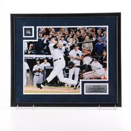 Photograph of Derek Jeter With Batting Glove Swatch From "The Final Hit In Yankees Stadium": A digital photograph of New York Yankees Major League Baseball player Derek Jeter presented with a piece of his game-worn batting gloves from the last game played at Yankee Stadium. The photograph depicts Jeter at bat. An attached plaque reads, “The Final Hit In Yankees Stadium.” The items are presented in white and navy blue matting in a black frame. There is an inscription on the verso by Steiner Sports. The piece is wired to the verso for hanging.