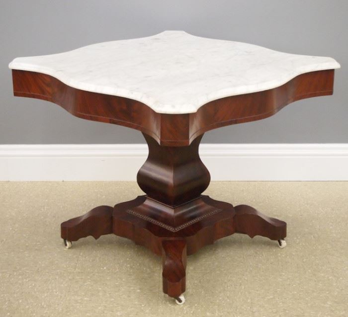 American Empire Period mahogany center table with marble top, 19th century.