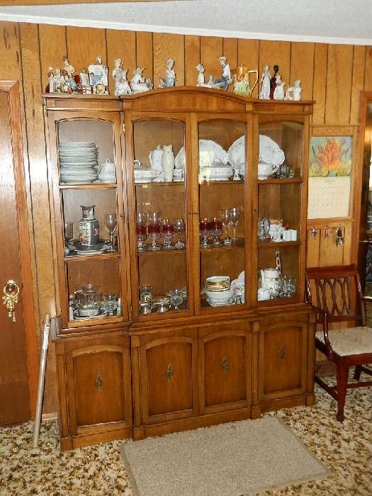 Drexel China cabinet loaded with fine china, vintage glassware, crystal, and Lladro figurines on top of cabinet