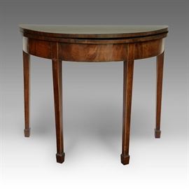 Early 19th century Hepplewhite Games Table in demilune form of flame mahogany woods. Â The top hinges and the table is raised on tapered legs with spade feet, 36" W x 29" H x 17 1/2" D.
Condition
Good: Top leaf is somewhat warped, wear consistent with age and use
Starting Bid
$75.00