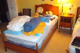 One of two twin beds & nite stand.