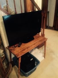 Flat screens and nice antique wood tables