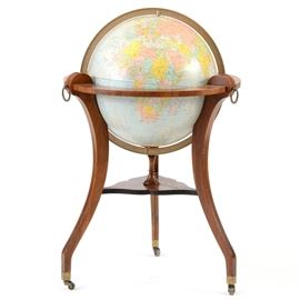 Regency Style Repogle Globe-on-Stand: A Repogle 16-inch, comprehensive globe, resting in a Regency style stand, having fine veneers and three saber legs with brass rings and ebony string inlay.