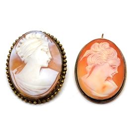 Two Vintage Shell Cameo Pendant Brooches in Silver Settings: A pair of vintage shell cameo pendant brooches set in silver. The larger cameo features a setting with beadwork detail marked “800” to reverse, while the smaller one has a simpler 925 sterling setting and is stamped “925 Italy.” Each item is convertible, functioning as pendant or brooch. The total combined weight, inclusive of all materials, is 0.540 ozt.