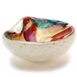 Vintage Art Glass Italian Murano Venetian Bowl: A vintage Italian art glass Murano Venetian bowl. The interior has elongated petals in pink, red, blue, and green along with gold. The exterior is opaque white with controlled bubbles throughout. There is a sticker reading “Genuine Venetian Glass Made in Murano Italy”.