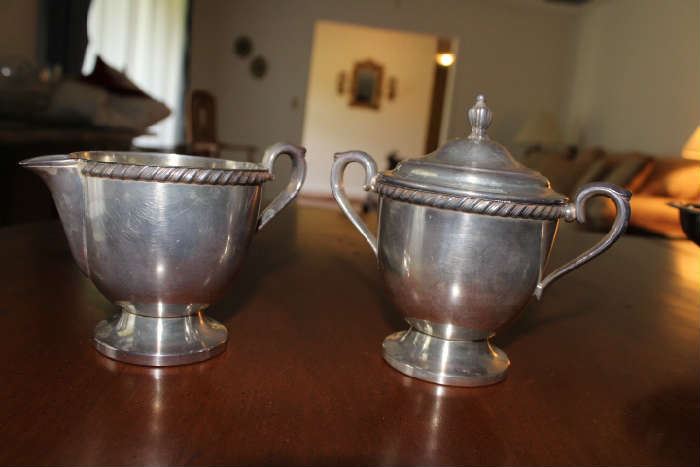 Silver Sugar and creamer.  It is marked Kenton Rogers with two small anchors on the bottom. The sugar 1703 and the creamer 1704. 
