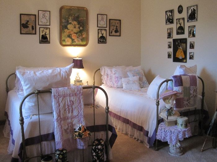 Matching twin antique beds, vintage linens and quilts, vintage art and silhouettes