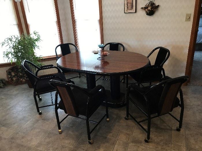 Modern Style Table and 6 rolling chairs.  Extra leaf was found after photo taken. 