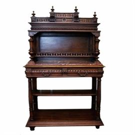 Antique German Wooden Hunt Chest: An antique German wooden hunt chest. This hunt chest has an intricate carved design throughout. The legs in the lower section have a turned wood design. There is a slab of marble on the table surface, in rose and cream tones. Beneath that are two drawers. Each has metal hardware pulls and a carved design on the front of the drawers. The drawers have dovetail joints. There are no makers marks on this piece.