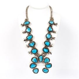 800 Silver Turquoise Squash Blossom Necklace: An 800 silver turquoise squash blossom necklace. This necklace has a single strand of sterling silver beads, and a row of turquoise.