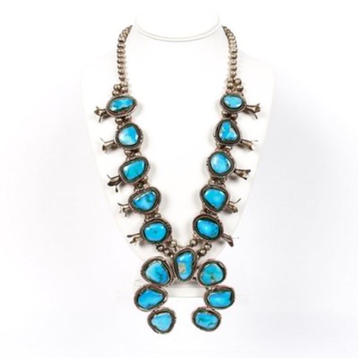 800 Silver Turquoise Squash Blossom Necklace: An 800 silver turquoise squash blossom necklace. This necklace has a single strand of sterling silver beads, and a row of turquoise.