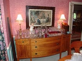 Antique buffet with assortment of stemware and Kings Crown stemware (red colored)