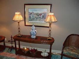 Glass and wood top sofa table with 2 lamps  and framed and matted horse print, some Memphis carnival objects on bottom shelf