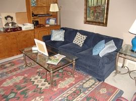 Blue corduroy sofa and glass top table