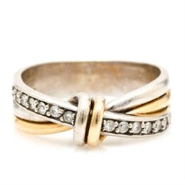 14K Two Tone Gold Diamond Ring: A 14K two-tone gold diamond ring. This ring features a knotted crown leading to textured shoulders. There is a diagonal row of prong set diamonds.