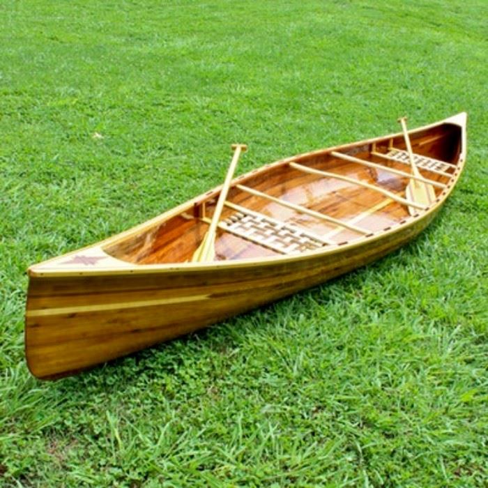 16 ft. Handmade Cedar Strip Canoe: A 16 ft. handmade cedar strip canoe. The canoe is made of multi shades of cedar strips with inlay details. The seats are handmade out of Aspen wood and Nylon webbing. Oars are handmade out of cedar and aspen wood. Oars and inside of boat marked to the inside RG-02-1.