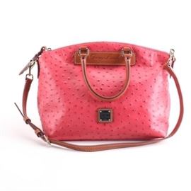 Dooney & Bourke Embossed Handbag: A Dooney & Bourke embossed handbag. This dual-handled bag showcases pink, ostrich embossed Florentine Vacchetta leather. It includes a dust bag, an adjustable shoulder strap, and is accented with tan leather. The bag is numbered J1598991 and is labeled by the manufacturer.