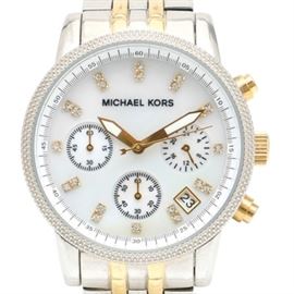 Michael Kors Two-Tone Stainless Steel Wristwatch: A Michael Kors wristwatch with a two-tone stainless steel, Jubilee bracelet leading to a beaded bezel housing a mother of pearl dial. The dial features glass crystal hour indicators, gold tone hands with white accents, and four subdials. Included with this watch is a black velvet storage bag and instruction manual.
