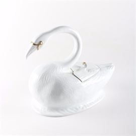Vintage Porcelain Swan Tureen: A porcelain swan tureen. This white porcelain tureen depicts a swan with curved neck, gold-tone accents and an open back with lid that opens to reveal deep bowl.