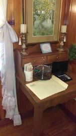 approx. 30" wide solid wood desk with two drawers great for any space but perfect for any small space  $180, brass candle holders $10 each, framed art $10, 2 tier silver plate trivet $10