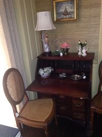 Small antique secretary; one of four cane chairs