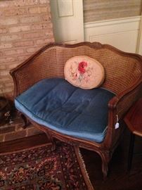 Cane French settee with blue cushion