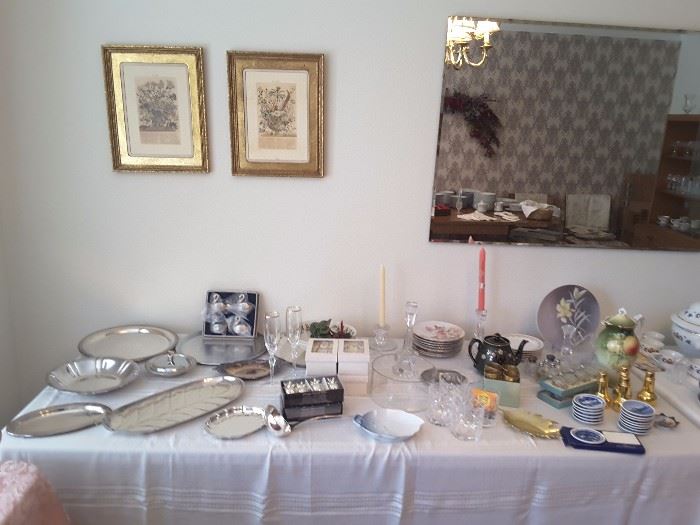 Silver plated serving ware, salt and pepper shakers, small collectible, crystal candle holder, miniature round travel collectible plates blue and white, tea pots, and beautiful items. Framed harvest pictures. Large Dining Room Mirror.