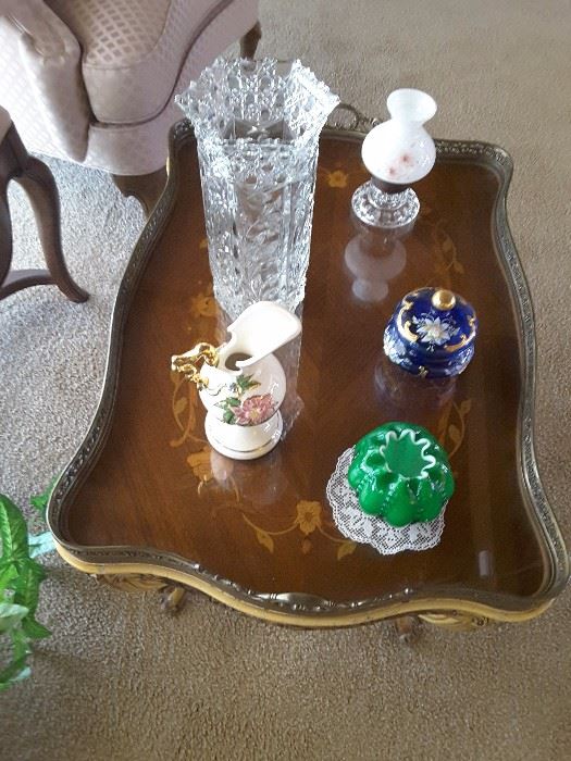 Living Room beautifully inlaid side table. Collectibles - oil lantern, blue decorative Austrian box and lid, green small vase with Dollie, ceramic pottery vase,pitcher, and tall crystal vase.