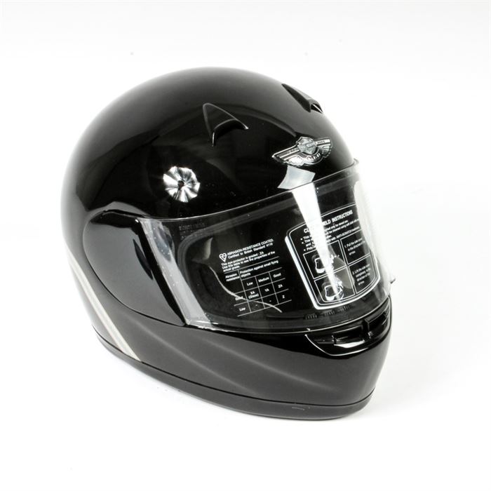 Harley-Davidson Motorcycle Helmet: A Harley-Davidson motorcycle helmet. Featured here is a black motorcycle riding helmet. On the front portion, there is a 100 year anniversary embellishment with silver tone accents on either side. Product specifications are recorded on a sticker across the front visor. This unused helmet comes with a branded black fabric storage bag with two carrying handles and an exterior pocket.