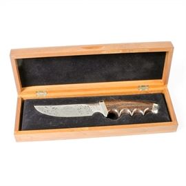 Limited Edition Harley-Davidson Gerber Knife: A limited edition Harley-Davidson Gerber knife. Featured here is a wooden handled knife with finger grips and a silver-tone metal blade. The blade of this knife is decorated with the Harley-Davidson logo and a filigree pattern. The back of the blade reads “Commemorating the Return to Private Ownership of the Harley-Davidson Motor Company, June 1981, Model 525”. The hilt of the knife is numbered 2430/3000 and the base of the blade is marked “Gerber, 97223”. This knife comes displayed in a black felt lined, wooden box emblazoned with the Harley-Davidson logo.