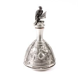 "Wartime Wheels" Pewter Harley-Davidson Decanter by GERZ: A Wartime Wheels pewter Harley-Davidson decanter by GERZ. Featured here is a solid pewter, bell-shaped, liquor decanter with an eagle perched on the lid. On one side of the base of the bell is an intricate depiction of a motorcycle rider on his bike with a sidecar. Beneath the scene, it reads “First Yank in Germany”. The other two sides show a man fixing his motorcycle and a man riding a motorcycle with a gun attached to the bike frame. The bottom of the decanter is marked “Harley-Davidson, 1990, Limited Edition 960 of 2000, GERZ Made in W. Germany”. A certificate of authenticity is included.