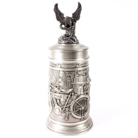 German Pewter Harley-Davidson Stein by GERZ: A German pewter Harley-Davidson stein by GERZ. Featured here is a handled beer stein with a lid embellished with an eagle. The sides of the stein depict a bicycle workshop scene. It is marked on the bottom “Harley Davidson, Brookfield Collectors Guild, Limited Edition 249 of 2000, GERZ, Made in W.Germany”.