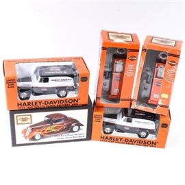 Harley-Davidson Branded Die Cast Coin Banks: A group of Harley-Davidson brand coin banks. There are five coin banks in the group, with three vehicles and two gas pumps. All are in the original boxes, marked “Harley-Davidson”, along with the name of the replica coin.