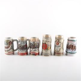 Ceramic Beer Steins: A collection of six decorated ceramic beer steins. Includes four Budweiser steins, one Anheuser-Busch Stein, and one Stroh’s stein. The steins are marked to their undersides.