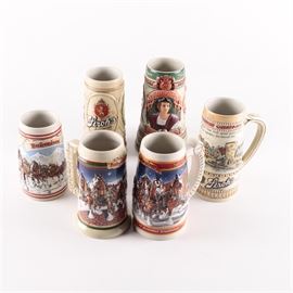 Decorated Ceramic Beer Steins: A collection of six decorated ceramic beer steins. Includes one Christopher Columbus stein, two Stroh’s steins, and three Budweiser steins. The steins are marked to their undersides.
