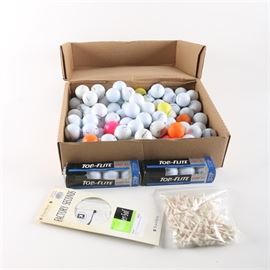 Golf Accessories: A collection of golf accessories. Includes a box of golf balls, two packages of Top-Flite golf balls, a pair of FootJoy golf gloves in their original packaging, and a bag of golf tees.