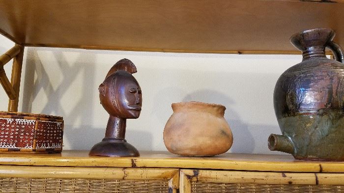duplicate of kumeyaay pot, moved things around, pottery vessel with screw in lid, African carving, etc.