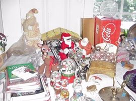 Lots of snow globes,Coca Cola, and reindeer collectibles