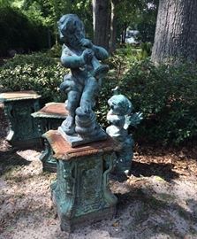 320b  Heavy cast iron set of 4 winged cupids on pedestal, 56 in .T including pedestal