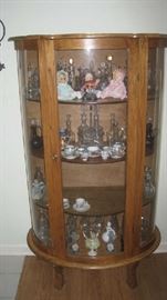Bow front china cabinet with cruet bottle collection 