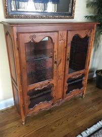 Lighted display cabinet. Measures 16" deep by 48" wide by 50 1/2" tall. No visible manufacturer's marks. 