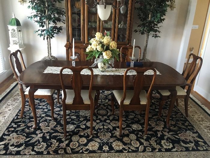 Gorgeous cherry table and 6 chairs. Leaves measure 14" each. 2 leaves. Table is 65" without any leaves. No mark on table other than the maker of the slides for the leaves. Chairs are marked Singer Furniture Company. 