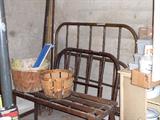 Old iron bed and wash tub stand.