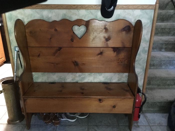 Wooden bench with storage under seat .