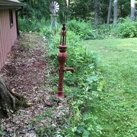 Antique Red water pump and garden size windmill. 
