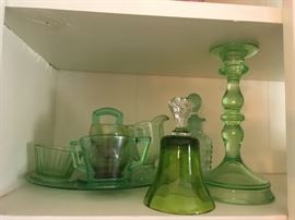 Several early green glass serving pieces including a bell and candlestick