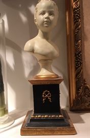 Pair of Ceramic child's bust on wooden stand