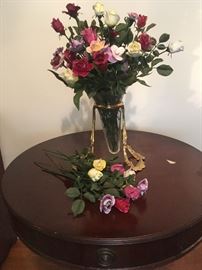Porcelain rosebuds in glass vase with brass holder