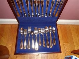 Set of stainless flatware in wooden box