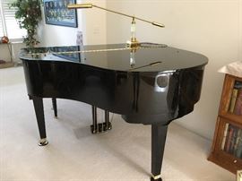 This beautiful baby grand piano has been professionally checked and is in tune -- a wonderful statement piece.